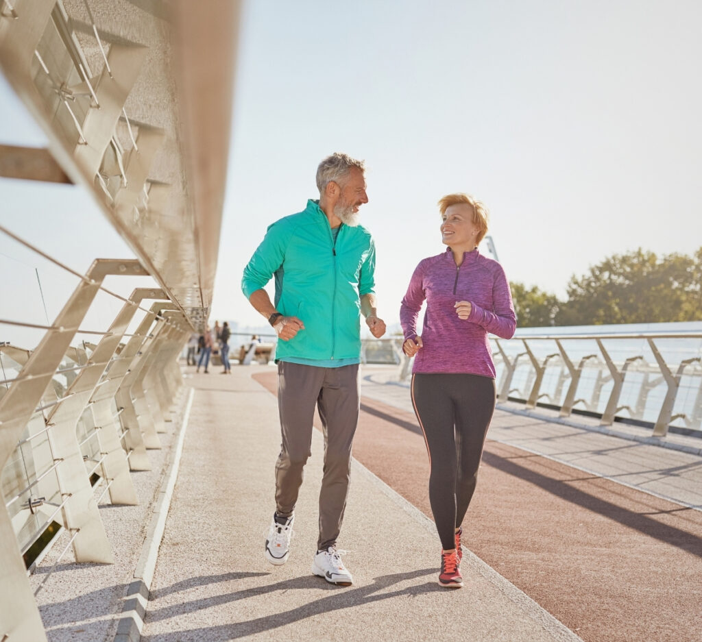 A stock image of a middle-aged couple jogging. Enjoy your free time without as many financial worries with the Jordanich Group -timeless financial values.
